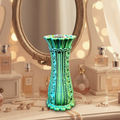 Lace filigree trinket bowl vase in blue green bronze gradient displayed on elegant vanity with jewelry inside bowl top