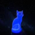 Xray Cat Lamp glowing blue against a starry night sky